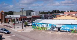 Downtown Forney, TX landscape featuring large mural on side of building with local decor