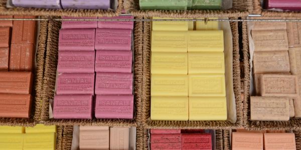 Colorful bar soaps displayed on burlap at an outdoor market