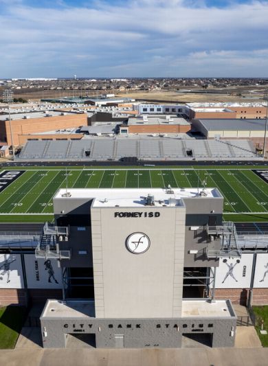 Aerial view of Forney Football Stadium with large playing field and empty stands