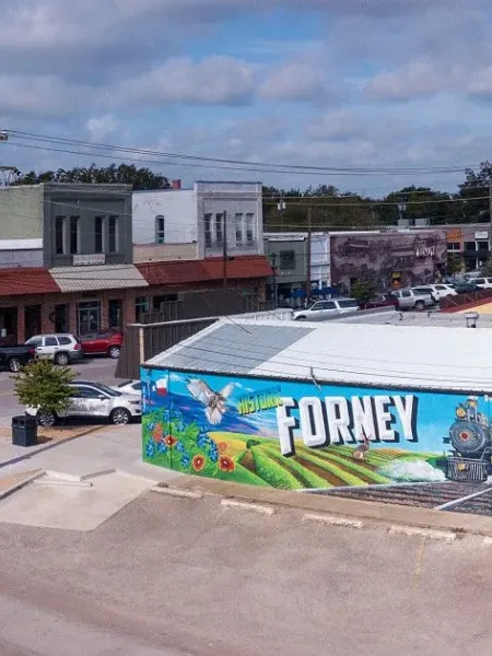 Downtown Forney, TX landscape featuring large mural on side of building with local decor