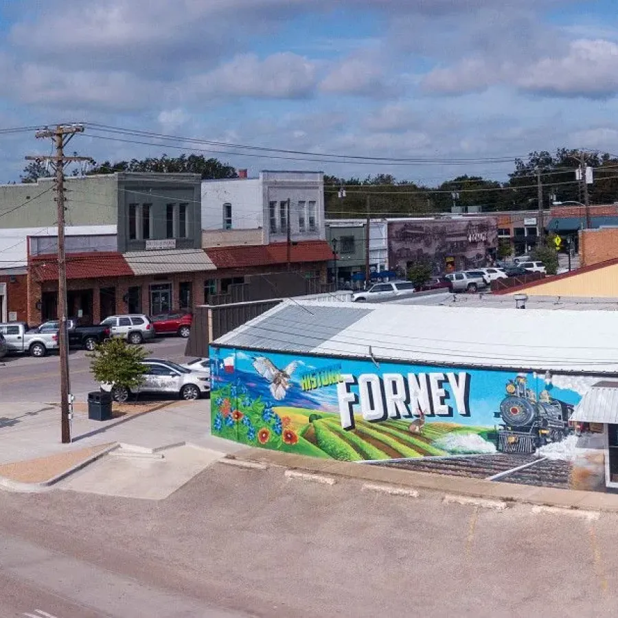 Downtown Forney, TX landscape featuring large mural on side of building with local decor